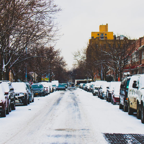 Snow Covered Road and Inline Parked Vehicles