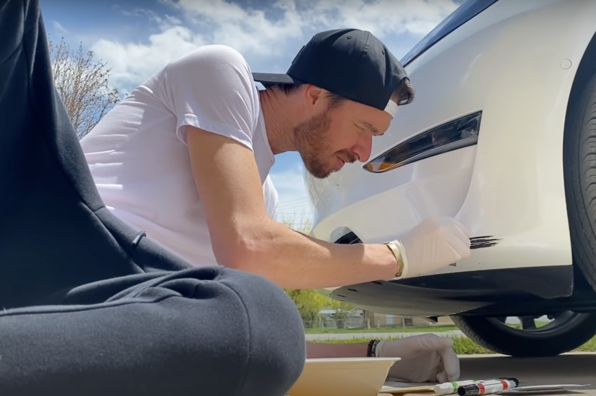 man painting car