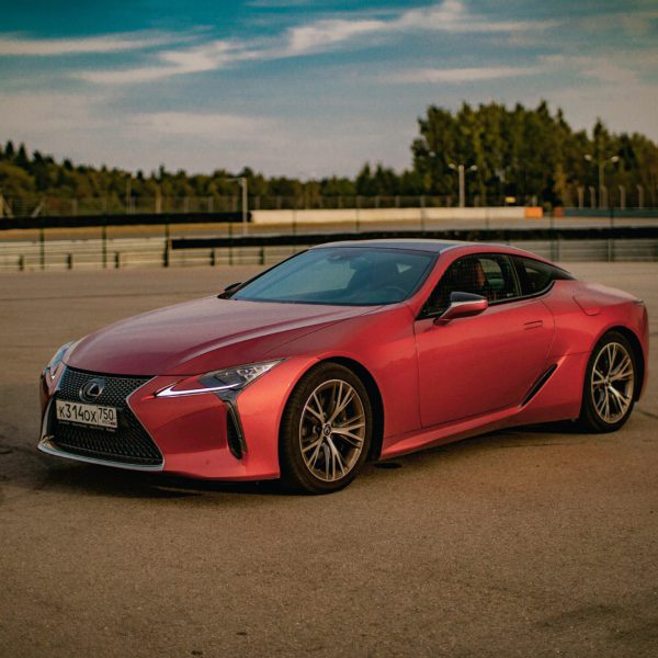 A photo of a red Lexus car in an outdoor setting