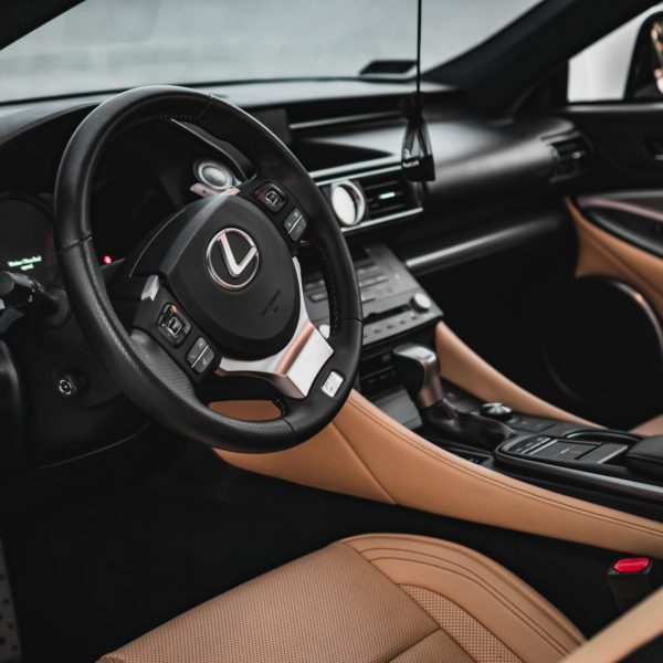 A photo of Lexus car with black and brown interior focusing on front seat view
