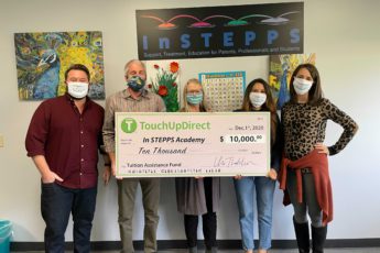 Touch up direct team handing over a huge check worth $10,000 for tuition assistance fund for the InSTEPPS academy