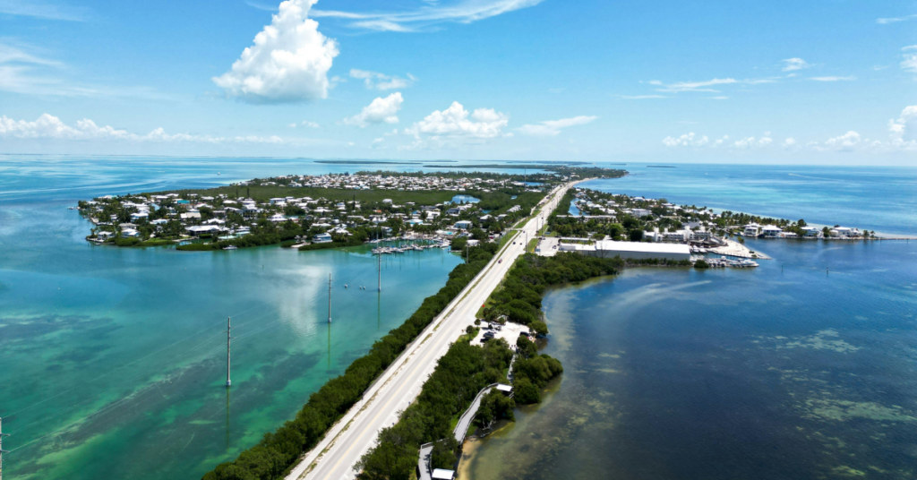 A long stretch of the Florida Keys Scenic Highway as it weaves through islands and water.

