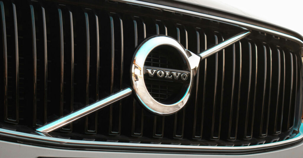 The Volvo emblem on the grille of one of their vehicles.