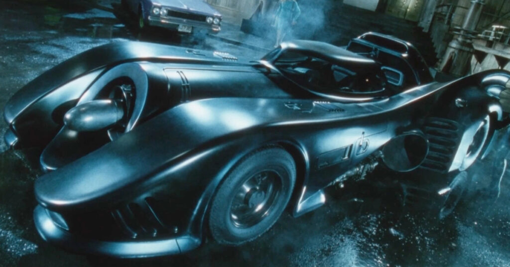 The long and sleek Batmobile from 1989's Batman as it sits on the rainy streets of Gotham.