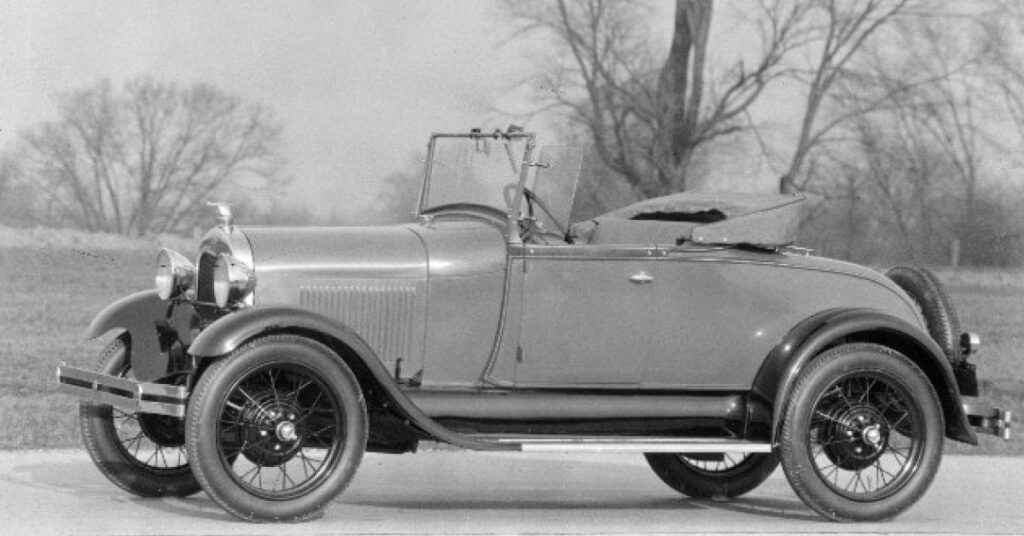 A black and white photo of a 1929 Ford Model A Roadster.